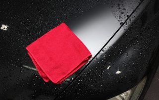 microfiber towel cleaning a car